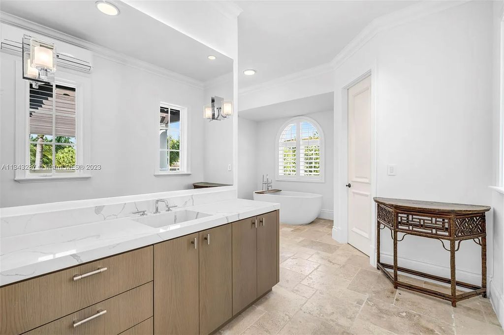 Experience luxurious waterfront living at 365 Arvida Pkwy, Coral Gables, Florida. This 11,946 sq ft masterpiece in Gables Estates offers 8 bedrooms, 11 baths, and 180 ft of waterfrontage. The main suite features a private balcony, spa-like bathroom, and walk-in closets.