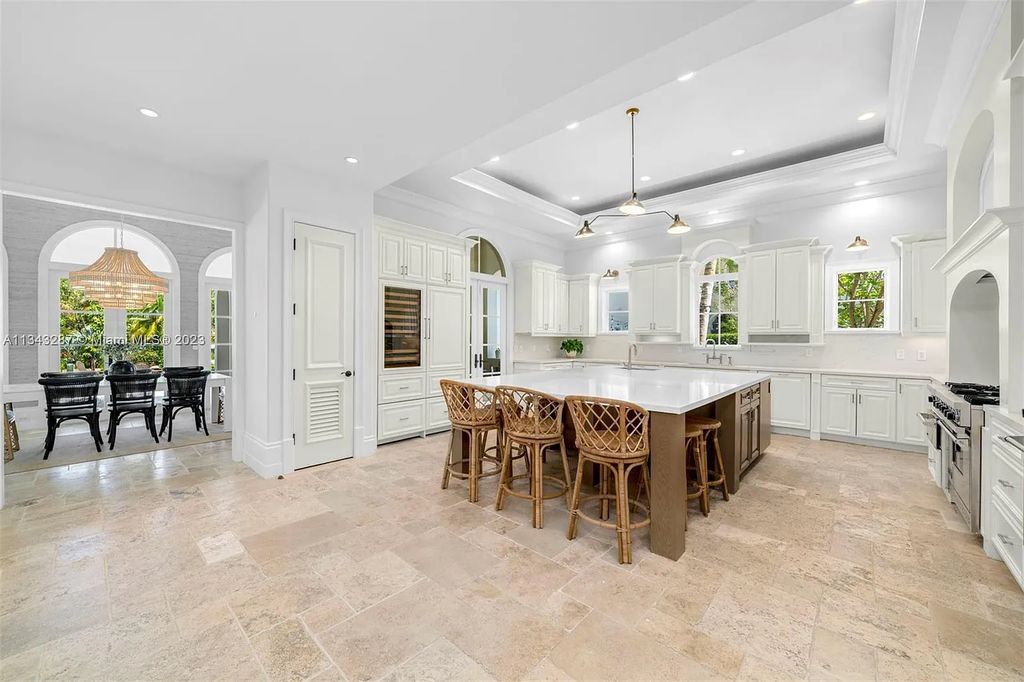 Experience luxurious waterfront living at 365 Arvida Pkwy, Coral Gables, Florida. This 11,946 sq ft masterpiece in Gables Estates offers 8 bedrooms, 11 baths, and 180 ft of waterfrontage. The main suite features a private balcony, spa-like bathroom, and walk-in closets.