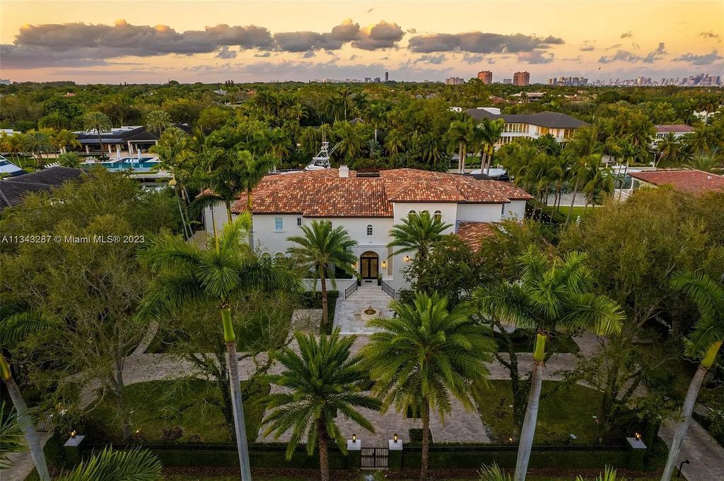 Experience luxurious waterfront living at 365 Arvida Pkwy, Coral Gables, Florida. This 11,946 sq ft masterpiece in Gables Estates offers 8 bedrooms, 11 baths, and 180 ft of waterfrontage. The main suite features a private balcony, spa-like bathroom, and walk-in closets.