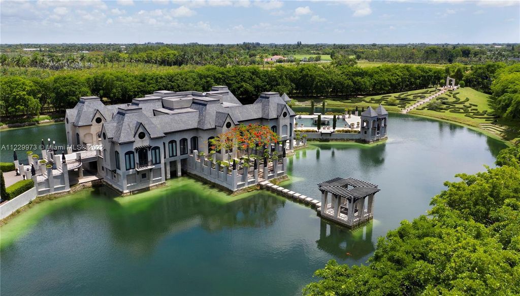 Welcome to 25791 SW 167th Avenue, Homestead, Florida - a rare chance to own the renowned mansion, designed by Architect Charles Sieger. This extraordinary 12,770 square feet estate sits on 13.74 acres in the serene Redlands area.