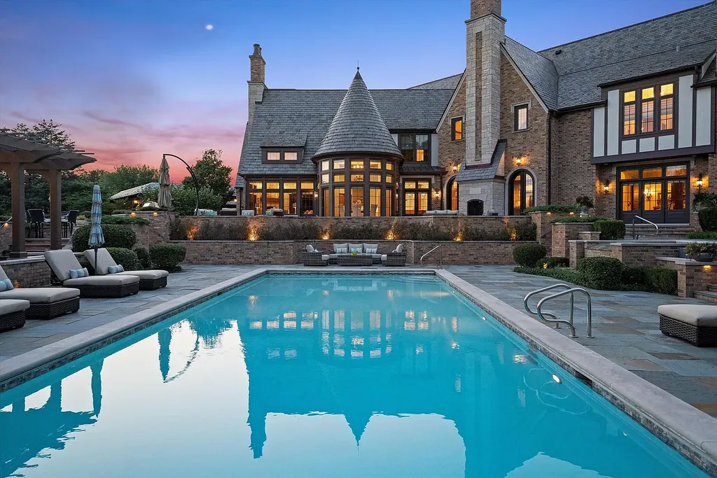 1112 Shamrock Court Home in Naperville, Illinois. Welcome to your own private resort-like manor in Naperville, one of America's top suburbs. This custom-built home by David Knecht offers over 21,000 square feet of luxury living space, including 7 bedrooms and 9.3 baths. The stunning exterior features Tudor-style brick and limestone, while the interior boasts top-of-the-line finishes and amenities. 