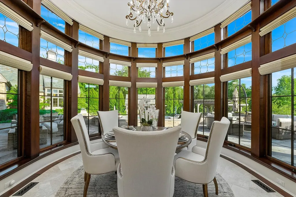 1112 Shamrock Court Home in Naperville, Illinois. Welcome to your own private resort-like manor in Naperville, one of America's top suburbs. This custom-built home by David Knecht offers over 21,000 square feet of luxury living space, including 7 bedrooms and 9.3 baths. The stunning exterior features Tudor-style brick and limestone, while the interior boasts top-of-the-line finishes and amenities. 