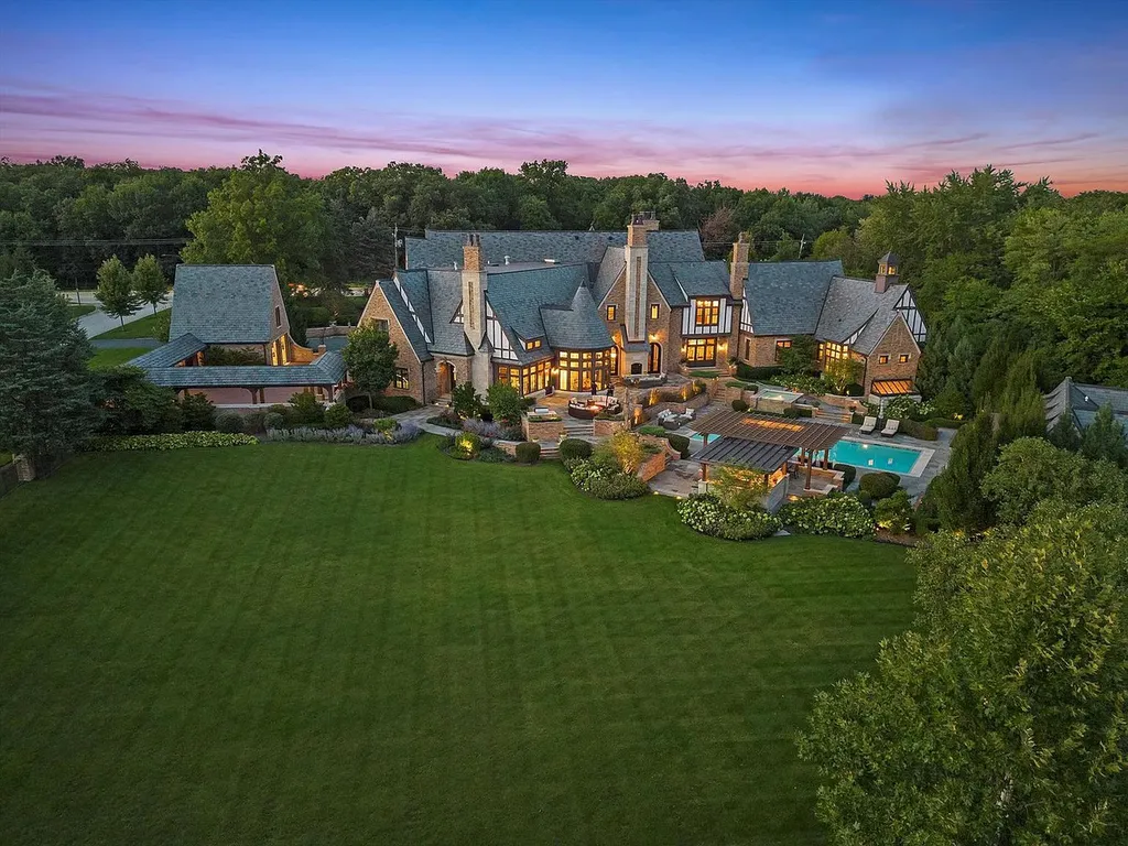 1112 Shamrock Court Home in Naperville, Illinois. Welcome to your own private resort-like manor in Naperville, one of America's top suburbs. This custom-built home by David Knecht offers over 21,000 square feet of luxury living space, including 7 bedrooms and 9.3 baths. The stunning exterior features Tudor-style brick and limestone, while the interior boasts top-of-the-line finishes and amenities. 
