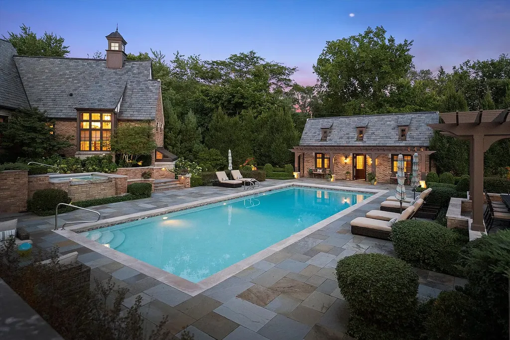 1112 Shamrock Court Home in Naperville, Illinois. Welcome to your own private resort-like manor in Naperville, one of America's top suburbs. This custom-built home by David Knecht offers over 21,000 square feet of luxury living space, including 7 bedrooms and 9.3 baths. The stunning exterior features Tudor-style brick and limestone, while the interior boasts top-of-the-line finishes and amenities. 