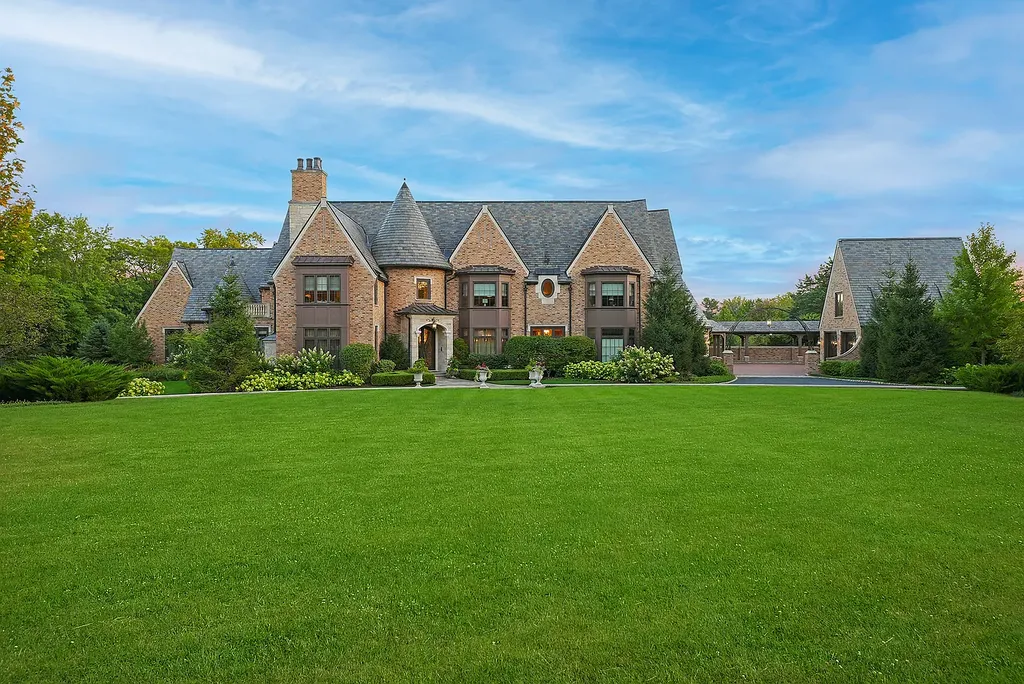 1112 Shamrock Court Home in Naperville, Illinois. Welcome to your own private resort-like manor in Naperville, one of America's top suburbs. This custom-built home by David Knecht offers over 21,000 square feet of luxury living space, including 7 bedrooms and 9.3 baths. The stunning exterior features Tudor-style brick and limestone, while the interior boasts top-of-the-line finishes and amenities. 