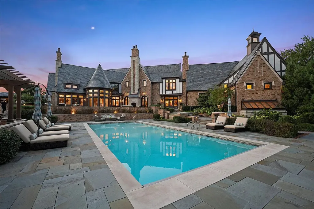 1112 Shamrock Court Home in Naperville, Illinois. Welcome to your own private resort-like manor in Naperville, one of America's top suburbs. This custom-built home by David Knecht offers over 21,000 square feet of luxury living space, including 7 bedrooms and 9.3 baths. The stunning exterior features Tudor-style brick and limestone, while the interior boasts top-of-the-line finishes and amenities. 