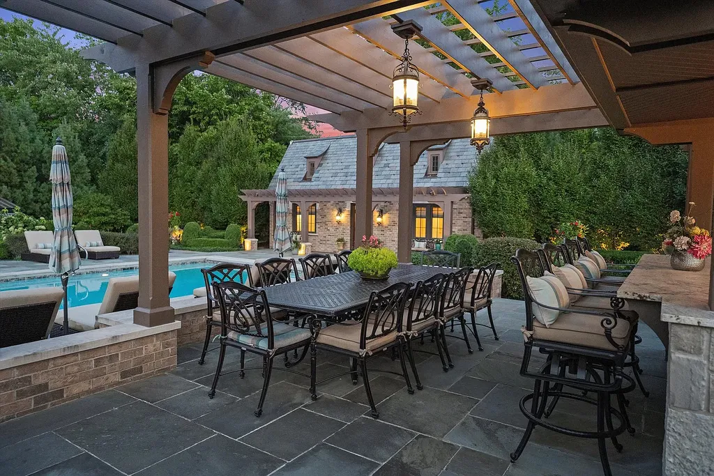 1112 Shamrock Court Home in Naperville, Illinois. Welcome to your own private resort-like manor in Naperville, one of America's top suburbs. This custom-built home by David Knecht offers over 21,000 square feet of luxury living space, including 7 bedrooms and 9.3 baths. The stunning exterior features Tudor-style brick and limestone, while the interior boasts top-of-the-line finishes and amenities. 