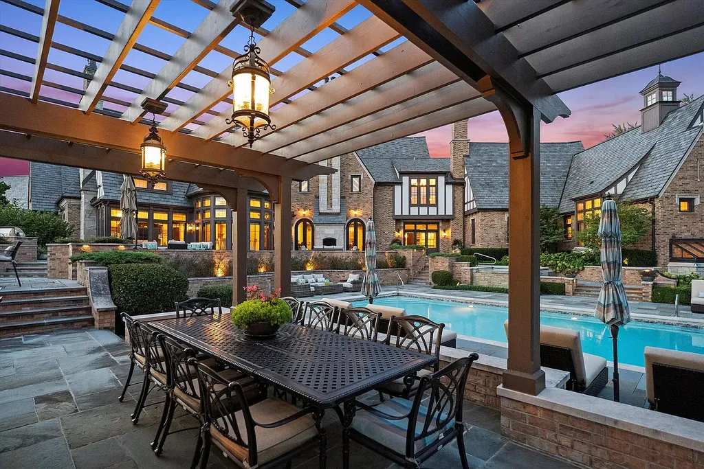 1112 Shamrock Court Home in Naperville, Illinois. Welcome to your own private resort-like manor in Naperville, one of America's top suburbs. This custom-built home by David Knecht offers over 21,000 square feet of luxury living space, including 7 bedrooms and 9.3 baths. The stunning exterior features Tudor-style brick and limestone, while the interior boasts top-of-the-line finishes and amenities. 