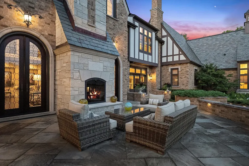 1112 Shamrock Court Home in Naperville, Illinois. Welcome to your own private resort-like manor in Naperville, one of America's top suburbs. This custom-built home by David Knecht offers over 21,000 square feet of luxury living space, including 7 bedrooms and 9.3 baths. The stunning exterior features Tudor-style brick and limestone, while the interior boasts top-of-the-line finishes and amenities. 