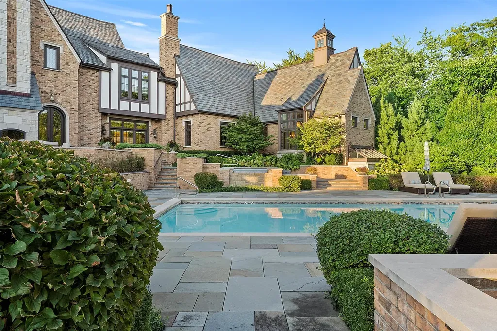 1112 Shamrock Court Home in Naperville, Illinois. Welcome to your own private resort-like manor in Naperville, one of America's top suburbs. This custom-built home by David Knecht offers over 21,000 square feet of luxury living space, including 7 bedrooms and 9.3 baths. The stunning exterior features Tudor-style brick and limestone, while the interior boasts top-of-the-line finishes and amenities. 