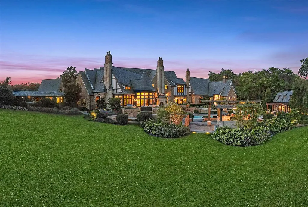 1112 Shamrock Court Home in Naperville, Illinois. Welcome to your own private resort-like manor in Naperville, one of America's top suburbs. This custom-built home by David Knecht offers over 21,000 square feet of luxury living space, including 7 bedrooms and 9.3 baths. The stunning exterior features Tudor-style brick and limestone, while the interior boasts top-of-the-line finishes and amenities. 