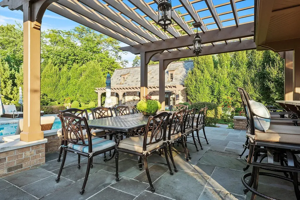 1112 Shamrock Court Home in Naperville, Illinois. Welcome to your own private resort-like manor in Naperville, one of America's top suburbs. This custom-built home by David Knecht offers over 21,000 square feet of luxury living space, including 7 bedrooms and 9.3 baths. The stunning exterior features Tudor-style brick and limestone, while the interior boasts top-of-the-line finishes and amenities. 