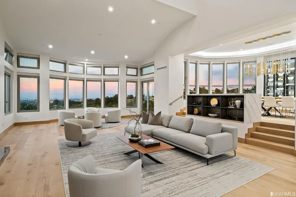 165 Woodridge Road Home in Hillsborough, California. Situated on 2.19 acres, this brand new state-of-the-art construction in Northern California boasts unobstructed, panoramic views as far as the eye can see. The architectural marvel features 26-ft high curved ceilings, rounded walls, and floor-to-ceiling windows, bathing the interior in natural light and showcasing breathtaking 180-degree bay and canyon vistas. Step onto the stunning limestone terrace, where a curved pool with a dancing water feature, spa, built-in Kalamazoo bbq station, outdoor shower, and access to a luxurious 2-bedroom, 2-bath guest house await. 