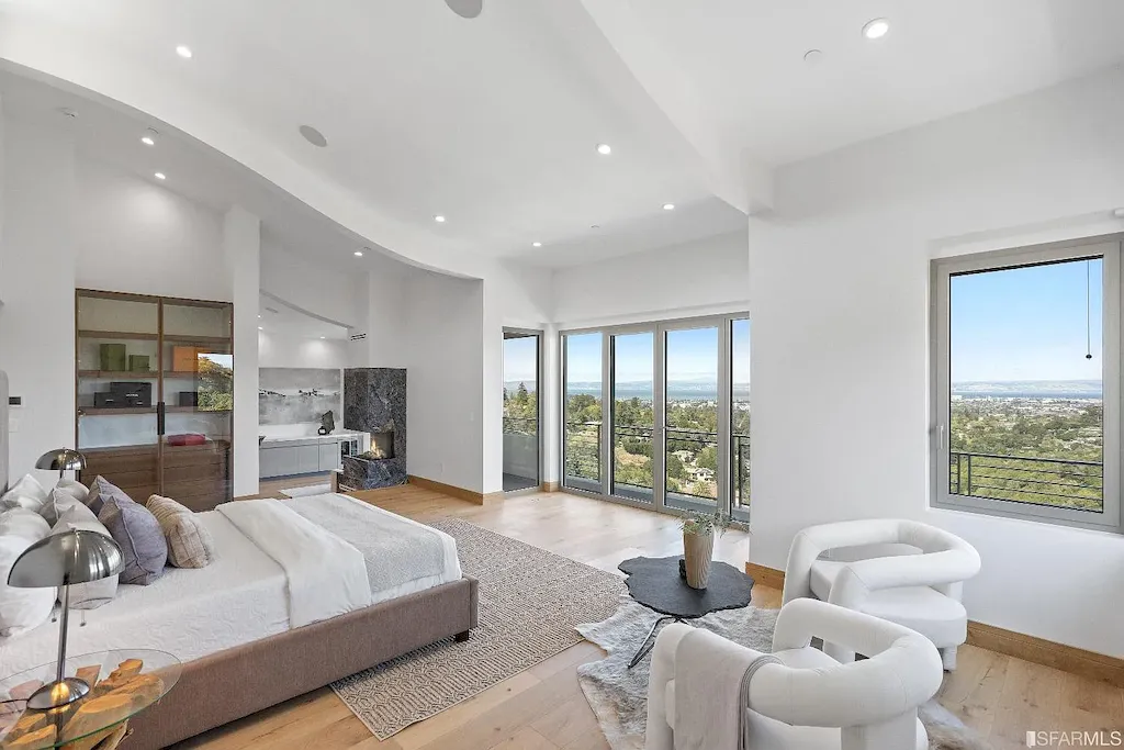 165 Woodridge Road Home in Hillsborough, California. Situated on 2.19 acres, this brand new state-of-the-art construction in Northern California boasts unobstructed, panoramic views as far as the eye can see. The architectural marvel features 26-ft high curved ceilings, rounded walls, and floor-to-ceiling windows, bathing the interior in natural light and showcasing breathtaking 180-degree bay and canyon vistas. Step onto the stunning limestone terrace, where a curved pool with a dancing water feature, spa, built-in Kalamazoo bbq station, outdoor shower, and access to a luxurious 2-bedroom, 2-bath guest house await. 