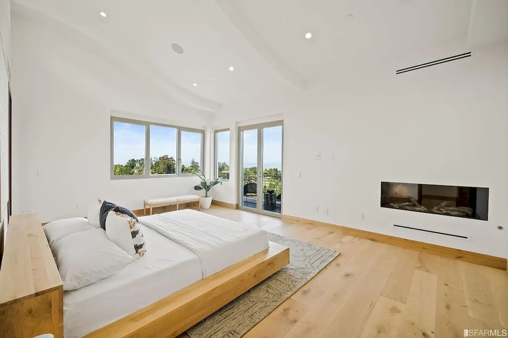 165 Woodridge Road Home in Hillsborough, California. Situated on 2.19 acres, this brand new state-of-the-art construction in Northern California boasts unobstructed, panoramic views as far as the eye can see. The architectural marvel features 26-ft high curved ceilings, rounded walls, and floor-to-ceiling windows, bathing the interior in natural light and showcasing breathtaking 180-degree bay and canyon vistas. Step onto the stunning limestone terrace, where a curved pool with a dancing water feature, spa, built-in Kalamazoo bbq station, outdoor shower, and access to a luxurious 2-bedroom, 2-bath guest house await. 