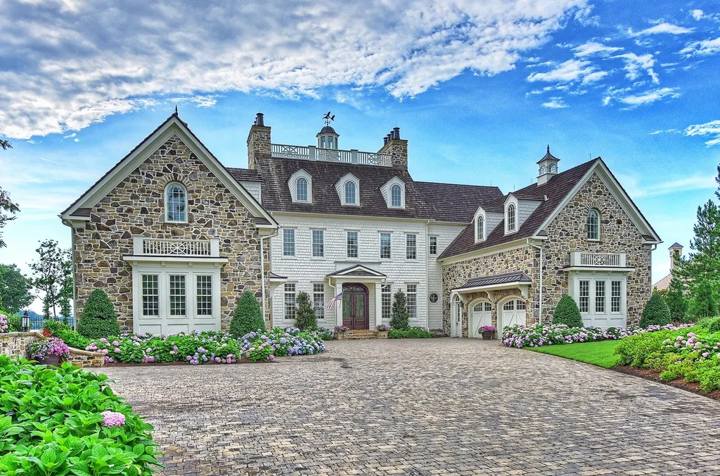 Indulge in the allure and character of the New England coast with this extraordinary Lake Norman estate. As you enter through the private gated drive, you'll be greeted by lush landscaping, creating a gardener's paradise. The estate offers wide open, long-range panoramic views that will take your breath away.