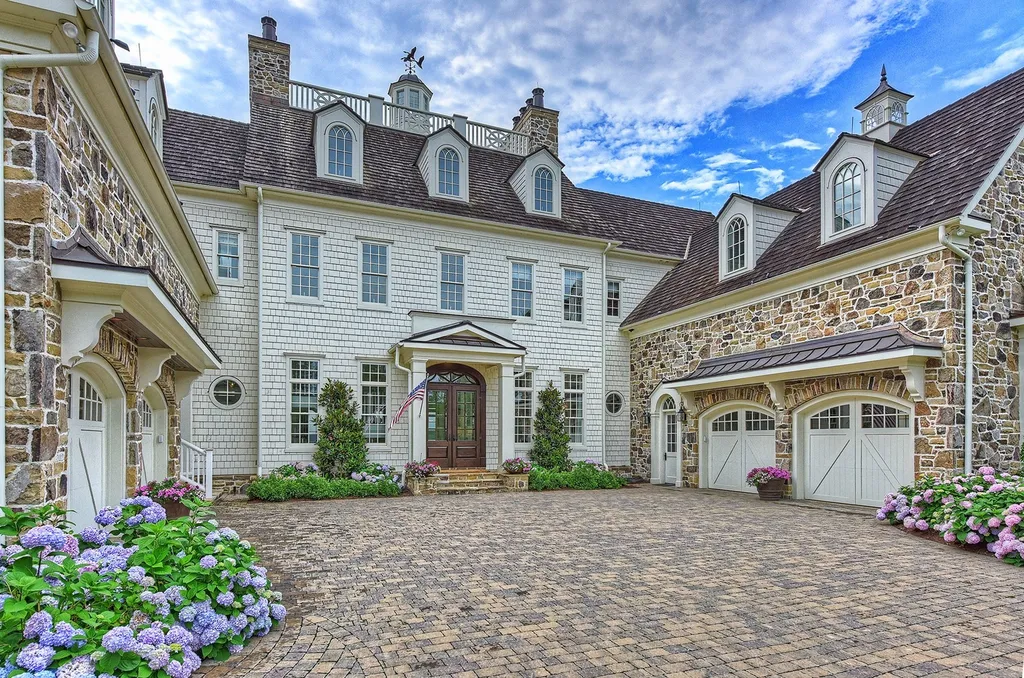Indulge in the allure and character of the New England coast with this extraordinary Lake Norman estate. As you enter through the private gated drive, you'll be greeted by lush landscaping, creating a gardener's paradise. The estate offers wide open, long-range panoramic views that will take your breath away.