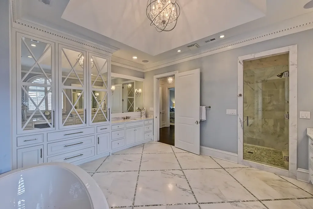 Indulge in the allure and character of the New England coast with this extraordinary Lake Norman estate. As you enter through the private gated drive, you'll be greeted by lush landscaping, creating a gardener's paradise. The estate offers wide open, long-range panoramic views that will take your breath away.