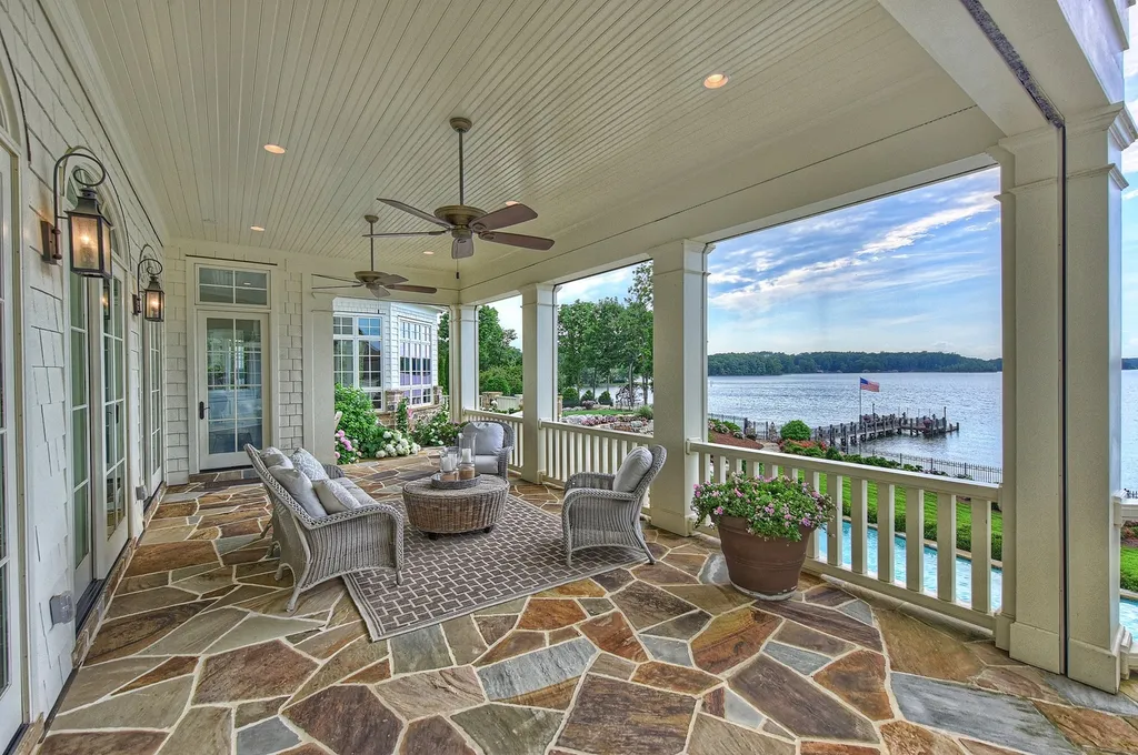 Indulge in the allure and character of the New England coast with this extraordinary Lake Norman estate. As you enter through the private gated drive, you'll be greeted by lush landscaping, creating a gardener's paradise. The estate offers wide open, long-range panoramic views that will take your breath away.