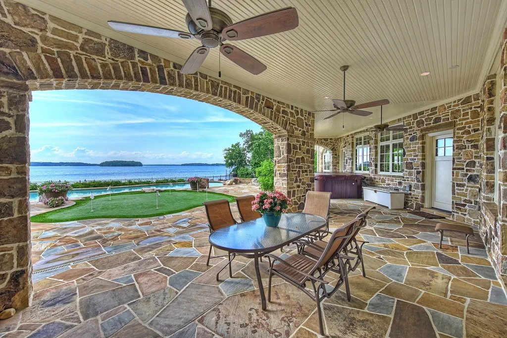 Indulge in the allure and character of the New England coast with this extraordinary Lake Norman estate. As you enter through the private gated drive, you'll be greeted by lush landscaping, creating a gardener's paradise. The estate offers wide open, long-range panoramic views that will take your breath away.