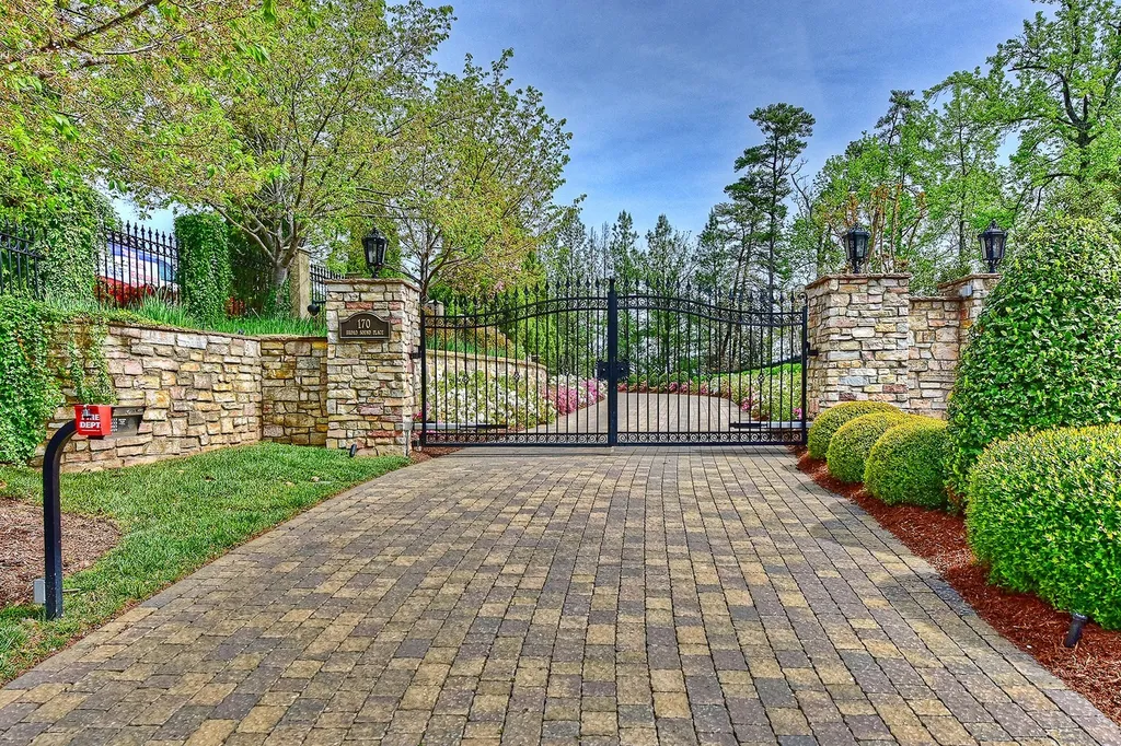 Indulge in the allure and character of the New England coast with this extraordinary Lake Norman estate. As you enter through the private gated drive, you'll be greeted by lush landscaping, creating a gardener's paradise. The estate offers wide open, long-range panoramic views that will take your breath away.