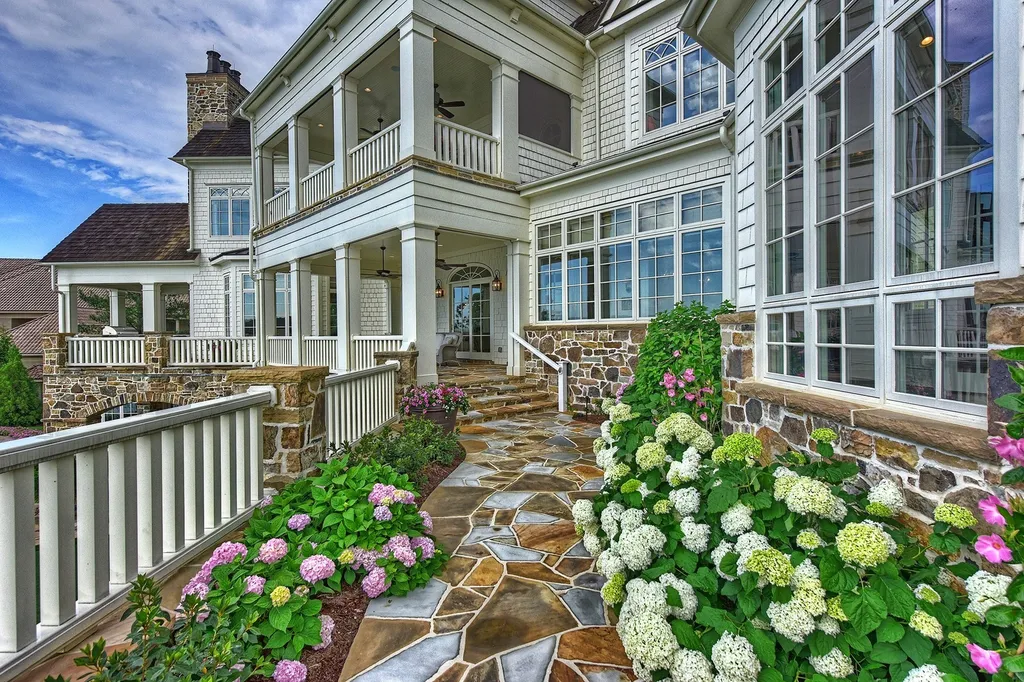 Indulge in the allure and character of the New England coast with this extraordinary Lake Norman estate. As you enter through the private gated drive, you'll be greeted by lush landscaping, creating a gardener's paradise. The estate offers wide open, long-range panoramic views that will take your breath away.