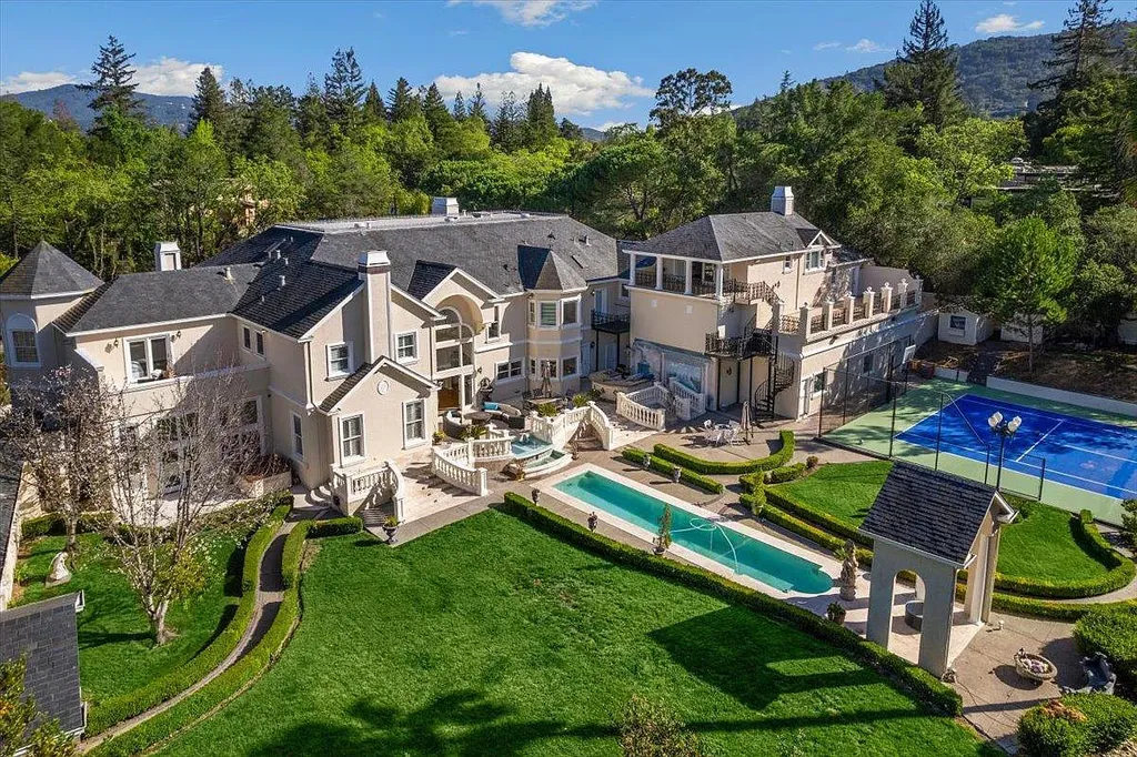 18911 Decatur Road Home in Los Gatos, California. This extraordinary estate in Monte Sereno has undergone a remarkable transformation with a remodel exceeding $5 million. It epitomizes the grandeur of a sprawling European luxury property, occupying a pristine and expansive 1.37-acre flat lot. This extraordinary estate in Monte Sereno has undergone a remarkable transformation with a remodel exceeding $5 million. It epitomizes the grandeur of a sprawling European luxury property, occupying a pristine and expansive 1.37-acre flat lot. The impressive slate roof structure encompasses approximately 17,000 square feet, boasting 10 bedrooms, 8 bathrooms, a separate guest house, an apartment, a 10-car garage, an elevator, an underground shooting range, an indoor basketball/racket ball court, a USTA tennis court, a resort-style lap pool, a great room, a home theatre, a bonus room, two formal libraries, and a home gym.