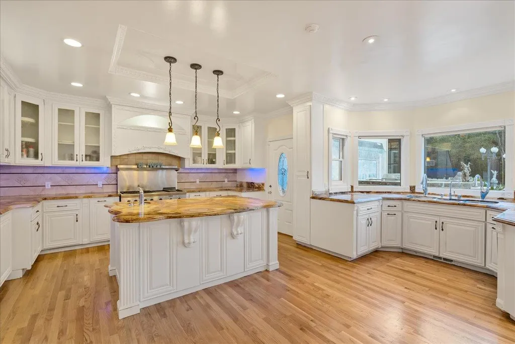 18911 Decatur Road Home in Los Gatos, California. This extraordinary estate in Monte Sereno has undergone a remarkable transformation with a remodel exceeding $5 million. It epitomizes the grandeur of a sprawling European luxury property, occupying a pristine and expansive 1.37-acre flat lot. This extraordinary estate in Monte Sereno has undergone a remarkable transformation with a remodel exceeding $5 million. It epitomizes the grandeur of a sprawling European luxury property, occupying a pristine and expansive 1.37-acre flat lot. The impressive slate roof structure encompasses approximately 17,000 square feet, boasting 10 bedrooms, 8 bathrooms, a separate guest house, an apartment, a 10-car garage, an elevator, an underground shooting range, an indoor basketball/racket ball court, a USTA tennis court, a resort-style lap pool, a great room, a home theatre, a bonus room, two formal libraries, and a home gym.