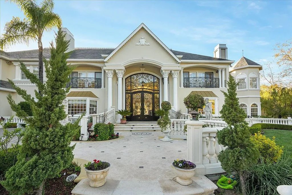 18911 Decatur Road Home in Los Gatos, California. This extraordinary estate in Monte Sereno has undergone a remarkable transformation with a remodel exceeding $5 million. It epitomizes the grandeur of a sprawling European luxury property, occupying a pristine and expansive 1.37-acre flat lot. This extraordinary estate in Monte Sereno has undergone a remarkable transformation with a remodel exceeding $5 million. It epitomizes the grandeur of a sprawling European luxury property, occupying a pristine and expansive 1.37-acre flat lot. The impressive slate roof structure encompasses approximately 17,000 square feet, boasting 10 bedrooms, 8 bathrooms, a separate guest house, an apartment, a 10-car garage, an elevator, an underground shooting range, an indoor basketball/racket ball court, a USTA tennis court, a resort-style lap pool, a great room, a home theatre, a bonus room, two formal libraries, and a home gym.