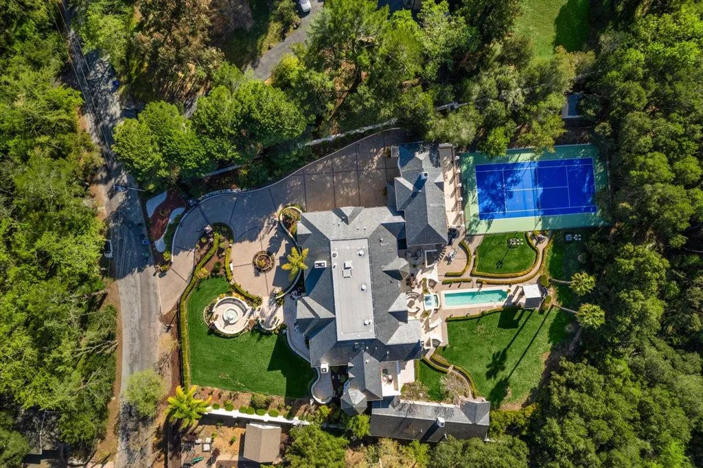 18911 Decatur Road Home in Los Gatos, California. This extraordinary estate in Monte Sereno has undergone a remarkable transformation with a remodel exceeding $5 million. It epitomizes the grandeur of a sprawling European luxury property, occupying a pristine and expansive 1.37-acre flat lot. This extraordinary estate in Monte Sereno has undergone a remarkable transformation with a remodel exceeding $5 million. It epitomizes the grandeur of a sprawling European luxury property, occupying a pristine and expansive 1.37-acre flat lot. The impressive slate roof structure encompasses approximately 17,000 square feet, boasting 10 bedrooms, 8 bathrooms, a separate guest house, an apartment, a 10-car garage, an elevator, an underground shooting range, an indoor basketball/racket ball court, a USTA tennis court, a resort-style lap pool, a great room, a home theatre, a bonus room, two formal libraries, and a home gym.