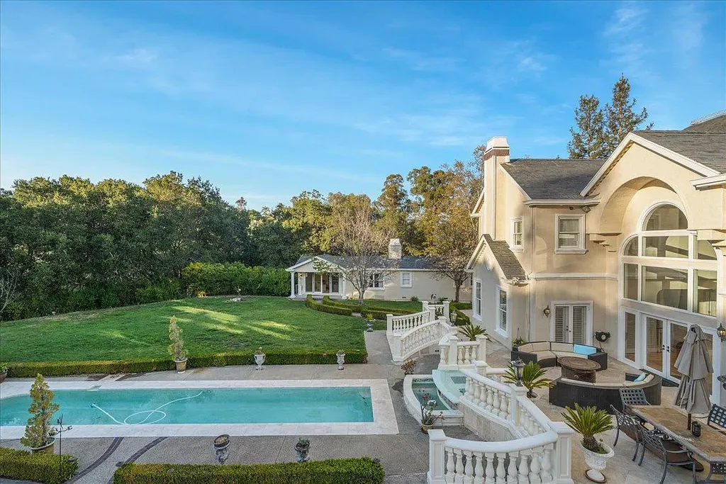18911 Decatur Road Home in Los Gatos, California. This extraordinary estate in Monte Sereno has undergone a remarkable transformation with a remodel exceeding $5 million. It epitomizes the grandeur of a sprawling European luxury property, occupying a pristine and expansive 1.37-acre flat lot. This extraordinary estate in Monte Sereno has undergone a remarkable transformation with a remodel exceeding $5 million. It epitomizes the grandeur of a sprawling European luxury property, occupying a pristine and expansive 1.37-acre flat lot. The impressive slate roof structure encompasses approximately 17,000 square feet, boasting 10 bedrooms, 8 bathrooms, a separate guest house, an apartment, a 10-car garage, an elevator, an underground shooting range, an indoor basketball/racket ball court, a USTA tennis court, a resort-style lap pool, a great room, a home theatre, a bonus room, two formal libraries, and a home gym.