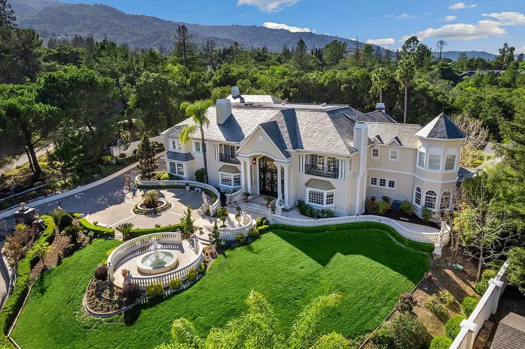 18911 Decatur Road Home in Los Gatos, California. This extraordinary estate in Monte Sereno has undergone a remarkable transformation with a remodel exceeding $5 million. It epitomizes the grandeur of a sprawling European luxury property, occupying a pristine and expansive 1.37-acre flat lot. This extraordinary estate in Monte Sereno has undergone a remarkable transformation with a remodel exceeding $5 million. It epitomizes the grandeur of a sprawling European luxury property, occupying a pristine and expansive 1.37-acre flat lot. The impressive slate roof structure encompasses approximately 17,000 square feet, boasting 10 bedrooms, 8 bathrooms, a separate guest house, an apartment, a 10-car garage, an elevator, an underground shooting range, an indoor basketball/racket ball court, a USTA tennis court, a resort-style lap pool, a great room, a home theatre, a bonus room, two formal libraries, and a home gym.