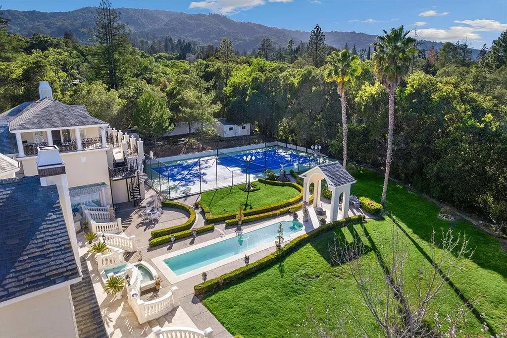 18911 Decatur Road Home in Los Gatos, California. This extraordinary estate in Monte Sereno has undergone a remarkable transformation with a remodel exceeding $5 million. It epitomizes the grandeur of a sprawling European luxury property, occupying a pristine and expansive 1.37-acre flat lot. This extraordinary estate in Monte Sereno has undergone a remarkable transformation with a remodel exceeding $5 million. It epitomizes the grandeur of a sprawling European luxury property, occupying a pristine and expansive 1.37-acre flat lot. The impressive slate roof structure encompasses approximately 17,000 square feet, boasting 10 bedrooms, 8 bathrooms, a separate guest house, an apartment, a 10-car garage, an elevator, an underground shooting range, an indoor basketball/racket ball court, a USTA tennis court, a resort-style lap pool, a great room, a home theatre, a bonus room, two formal libraries, and a home gym.