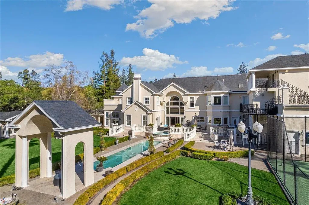 18911 Decatur Road Home in Los Gatos, California. This extraordinary estate in Monte Sereno has undergone a remarkable transformation with a remodel exceeding $5 million. It epitomizes the grandeur of a sprawling European luxury property, occupying a pristine and expansive 1.37-acre flat lot. This extraordinary estate in Monte Sereno has undergone a remarkable transformation with a remodel exceeding $5 million. It epitomizes the grandeur of a sprawling European luxury property, occupying a pristine and expansive 1.37-acre flat lot. The impressive slate roof structure encompasses approximately 17,000 square feet, boasting 10 bedrooms, 8 bathrooms, a separate guest house, an apartment, a 10-car garage, an elevator, an underground shooting range, an indoor basketball/racket ball court, a USTA tennis court, a resort-style lap pool, a great room, a home theatre, a bonus room, two formal libraries, and a home gym.
