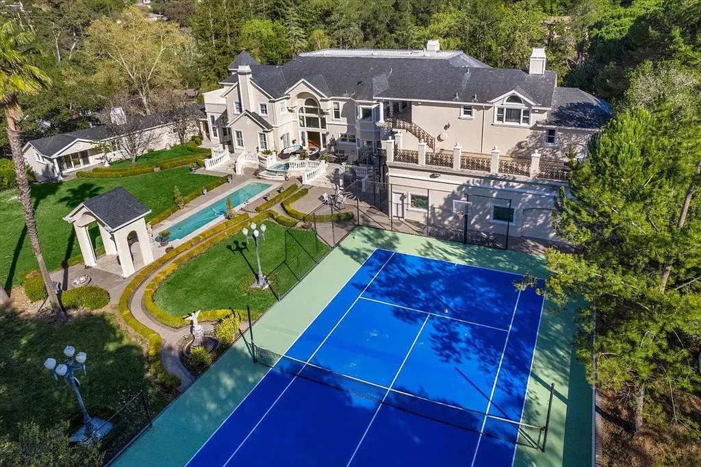 18911 Decatur Road Home in Los Gatos, California. This extraordinary estate in Monte Sereno has undergone a remarkable transformation with a remodel exceeding $5 million. It epitomizes the grandeur of a sprawling European luxury property, occupying a pristine and expansive 1.37-acre flat lot. This extraordinary estate in Monte Sereno has undergone a remarkable transformation with a remodel exceeding $5 million. It epitomizes the grandeur of a sprawling European luxury property, occupying a pristine and expansive 1.37-acre flat lot. The impressive slate roof structure encompasses approximately 17,000 square feet, boasting 10 bedrooms, 8 bathrooms, a separate guest house, an apartment, a 10-car garage, an elevator, an underground shooting range, an indoor basketball/racket ball court, a USTA tennis court, a resort-style lap pool, a great room, a home theatre, a bonus room, two formal libraries, and a home gym.