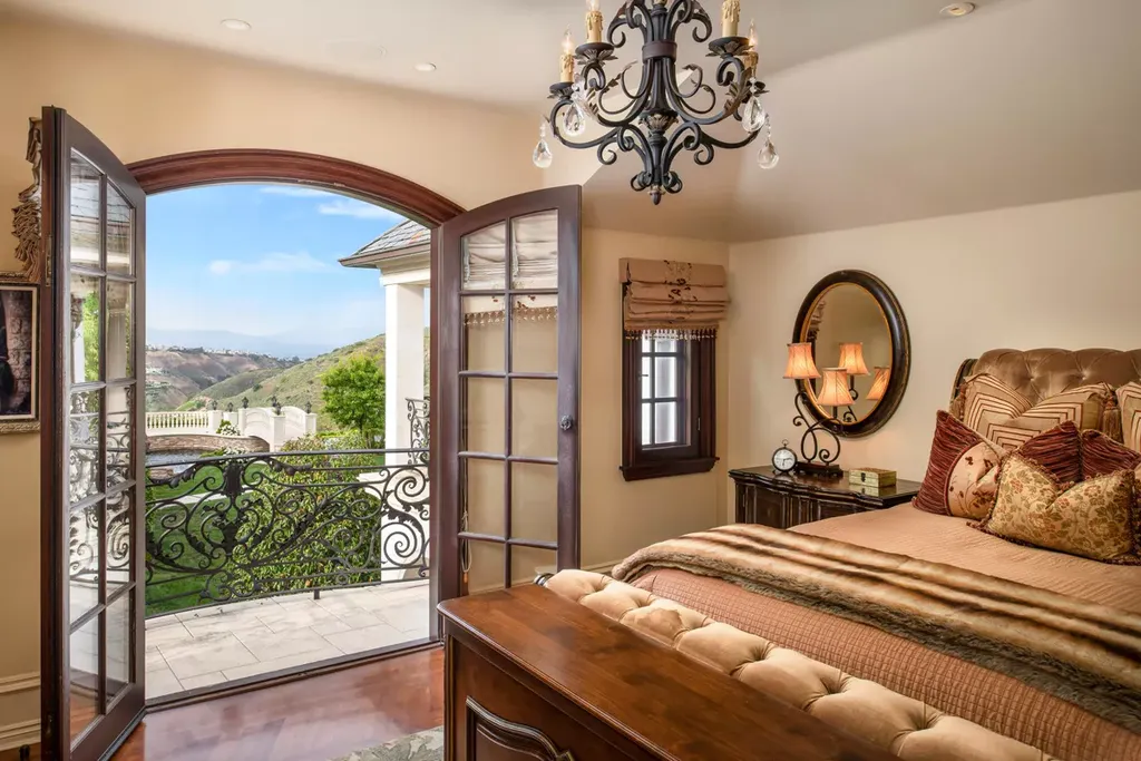 25365 Prado De La Felicidad Home in Calabasas, California. Calabasas, California - Prepare to be captivated by one of the most stunning properties in all of Calabasas. This extraordinary architectural masterpiece showcases French influence and design, nestled behind the prestigious second gate in The Estates at The Oaks. Situated on over 1.1 acres of land and boasting panoramic city and mountain views, this residence is a true testament to luxury and craftsmanship.