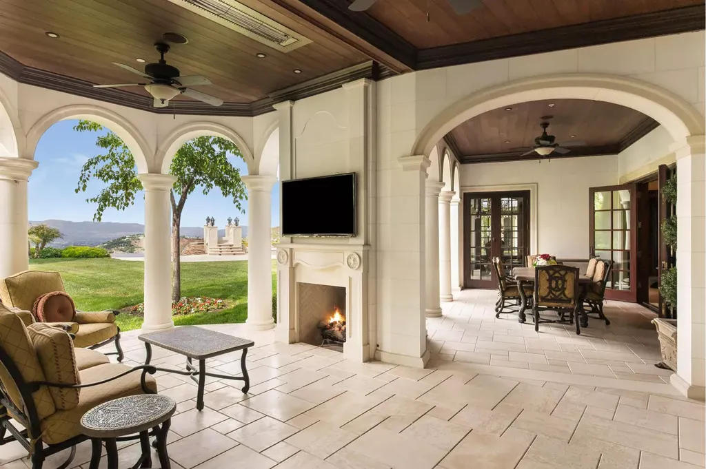 25365 Prado De La Felicidad Home in Calabasas, California. Calabasas, California - Prepare to be captivated by one of the most stunning properties in all of Calabasas. This extraordinary architectural masterpiece showcases French influence and design, nestled behind the prestigious second gate in The Estates at The Oaks. Situated on over 1.1 acres of land and boasting panoramic city and mountain views, this residence is a true testament to luxury and craftsmanship.