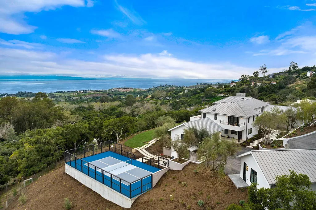 2957 E Valley Road Home in Santa Barbara, California. Embark on an extraordinary journey as you step into this newly completed, expertly designed compound boasting breathtaking ocean, mountain, and hillside views. With a harmonious blend of modern aesthetics and a romantic ambiance, this property is a testament to patience and the pursuit of perfection. Welcome to a haven where high design seamlessly merges with relaxed livability, creating an unparalleled living experience.