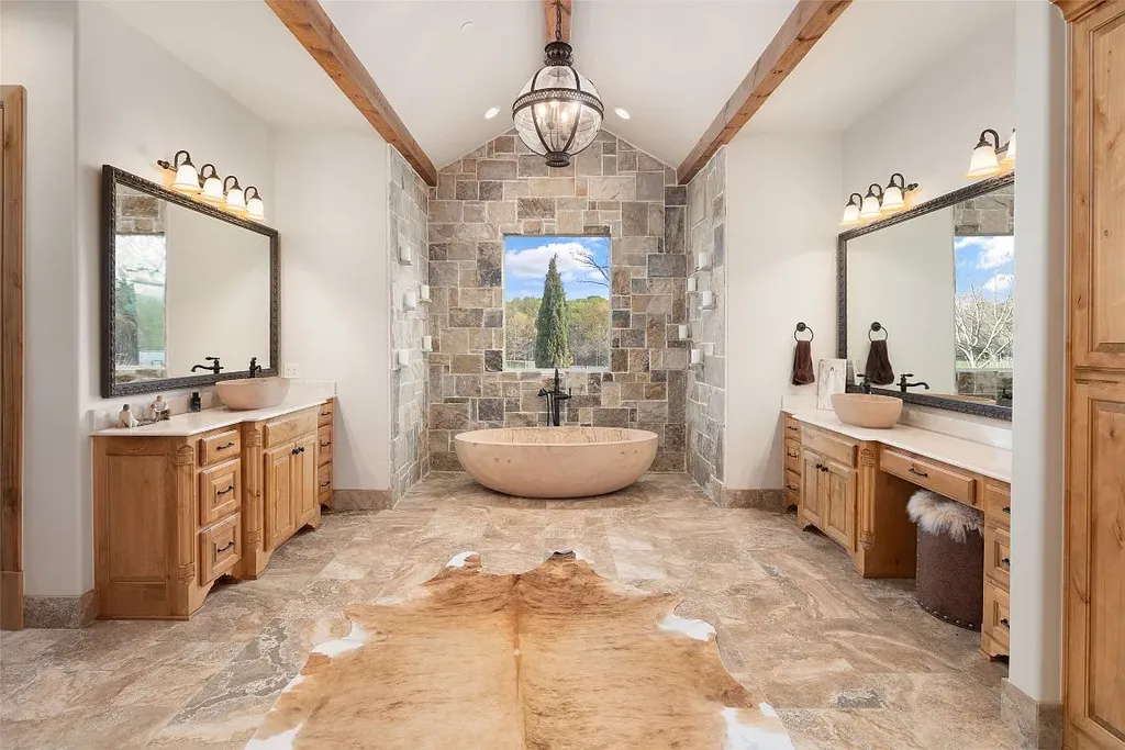 Experience the perfect blend of Texas Hill Country charm and modern urban living in this exceptional 5-bedroom, 6-bathroom home located on a peaceful cul-de-sac and nestled on 2.3 acres of scenic beauty, with the added advantage of being adjacent to an equestrian farm. The thoughtfully designed interiors showcase light woods, warm stones, and expansive windows, creating inviting and bright spaces throughout.