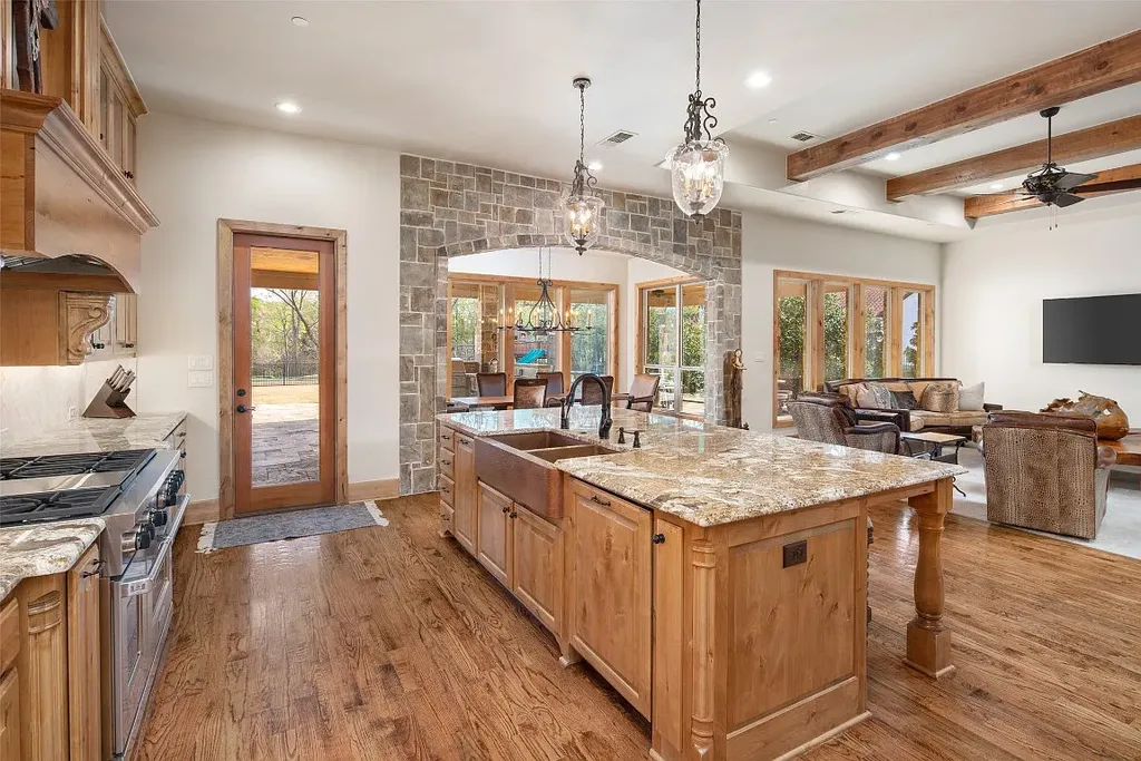 Experience the perfect blend of Texas Hill Country charm and modern urban living in this exceptional 5-bedroom, 6-bathroom home located on a peaceful cul-de-sac and nestled on 2.3 acres of scenic beauty, with the added advantage of being adjacent to an equestrian farm. The thoughtfully designed interiors showcase light woods, warm stones, and expansive windows, creating inviting and bright spaces throughout.