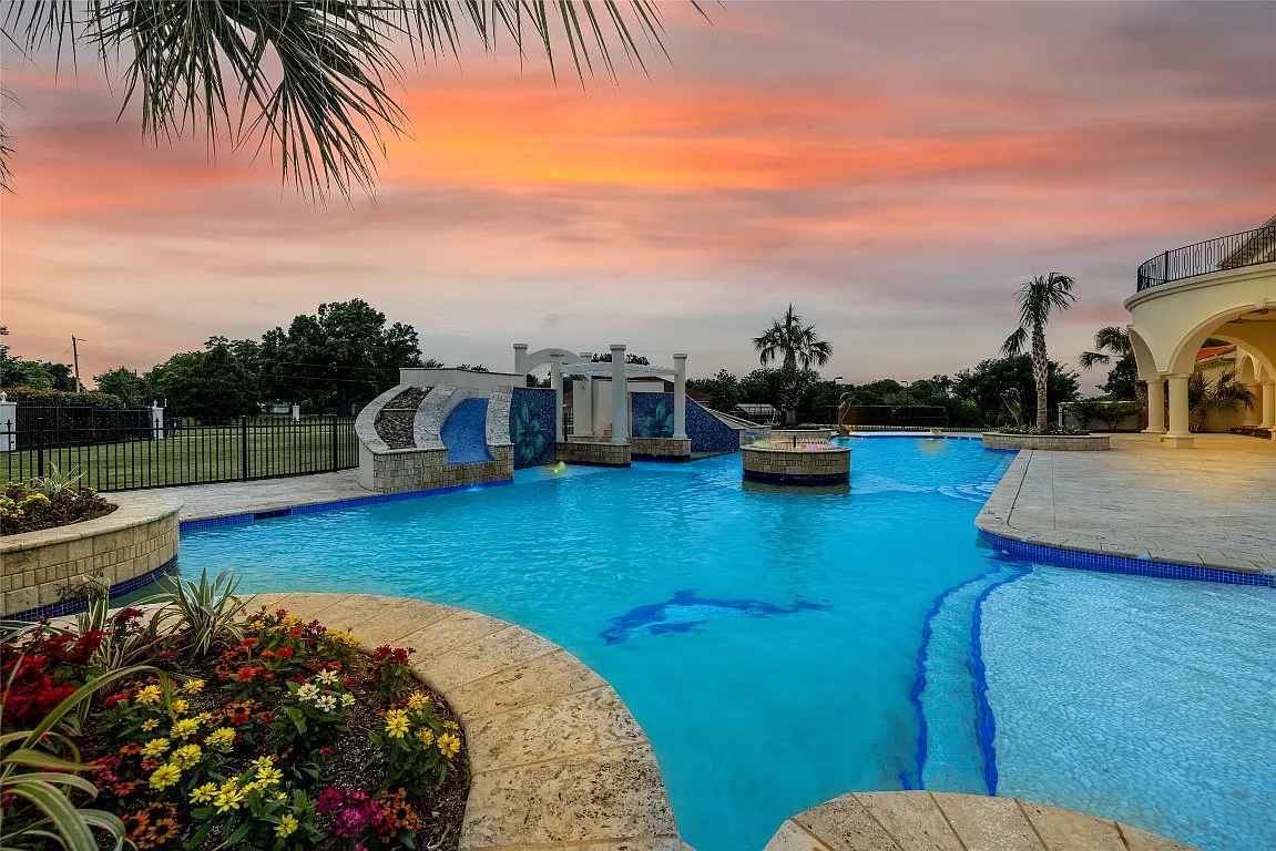 3712 Dustin Trail Home in Dalworthington Gardens, Texas. Experience the epitome of luxury and exclusivity with this breathtaking gated resort home situated on an expansive 8.5-acre estate. Every detail of this grand celebrity-style residence has been meticulously crafted, from the majestic cathedral ceilings to the mesmerizing views of the resort-style oasis.