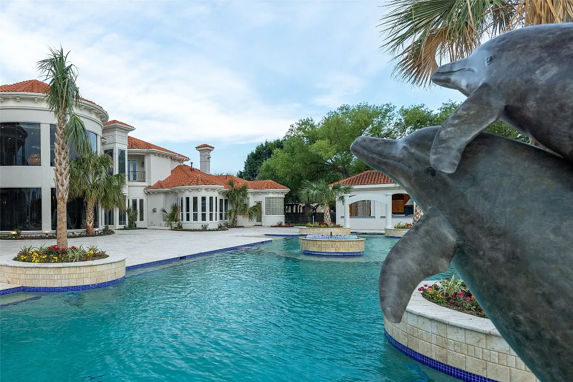 3712 Dustin Trail Home in Dalworthington Gardens, Texas. Experience the epitome of luxury and exclusivity with this breathtaking gated resort home situated on an expansive 8.5-acre estate. Every detail of this grand celebrity-style residence has been meticulously crafted, from the majestic cathedral ceilings to the mesmerizing views of the resort-style oasis.