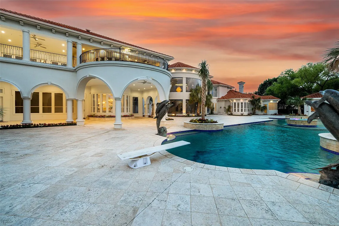 3712 Dustin Trail Home in Dalworthington Gardens, Texas. Experience the epitome of luxury and exclusivity with this breathtaking gated resort home situated on an expansive 8.5-acre estate. Every detail of this grand celebrity-style residence has been meticulously crafted, from the majestic cathedral ceilings to the mesmerizing views of the resort-style oasis.