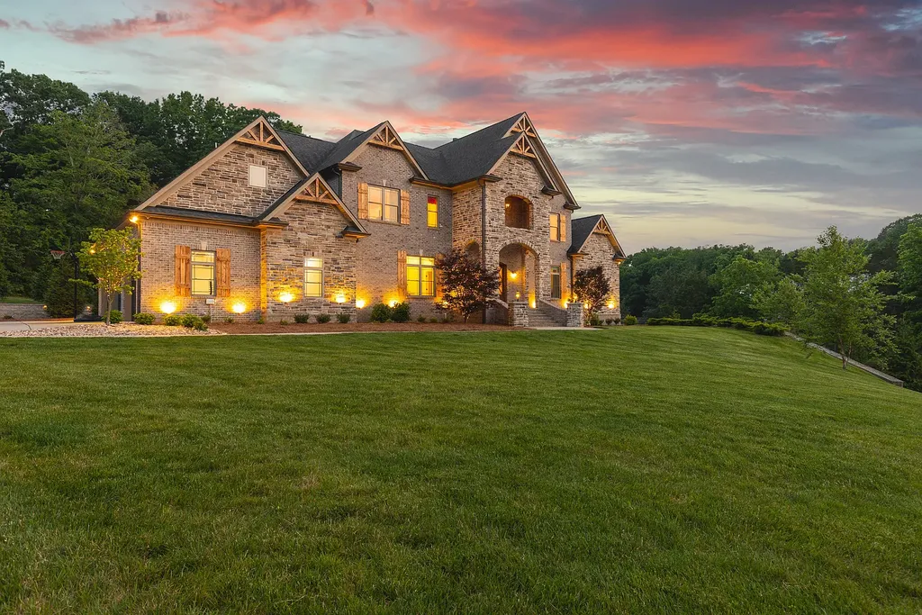 5078 Central Pike Home in Mount Juliet, Tennessee. Discover the epitome of luxury living in this stunning custom home situated on nearly 8 acres in Wilson County. Boasting a spacious floor plan, this residence features 5 bedroom suites, a workout room, a hobby room/office, and an outdoor entertaining area complete with a kitchen, custom pool, hot tub, and fire pit. Step into the indoor kitchen, which showcases leathered granite and quartz countertops, as well as a walk-in pantry. The main level and master bath offer the comfort of heated tile flooring.