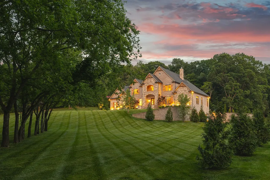 5078 Central Pike Home in Mount Juliet, Tennessee. Discover the epitome of luxury living in this stunning custom home situated on nearly 8 acres in Wilson County. Boasting a spacious floor plan, this residence features 5 bedroom suites, a workout room, a hobby room/office, and an outdoor entertaining area complete with a kitchen, custom pool, hot tub, and fire pit. Step into the indoor kitchen, which showcases leathered granite and quartz countertops, as well as a walk-in pantry. The main level and master bath offer the comfort of heated tile flooring.