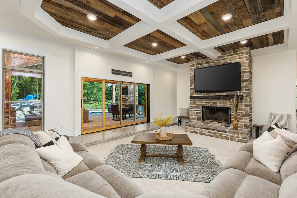 5078 Central Pike Home in Mount Juliet, Tennessee. Discover the epitome of luxury living in this stunning custom home situated on nearly 8 acres in Wilson County. Boasting a spacious floor plan, this residence features 5 bedroom suites, a workout room, a hobby room/office, and an outdoor entertaining area complete with a kitchen, custom pool, hot tub, and fire pit. Step into the indoor kitchen, which showcases leathered granite and quartz countertops, as well as a walk-in pantry. The main level and master bath offer the comfort of heated tile flooring.