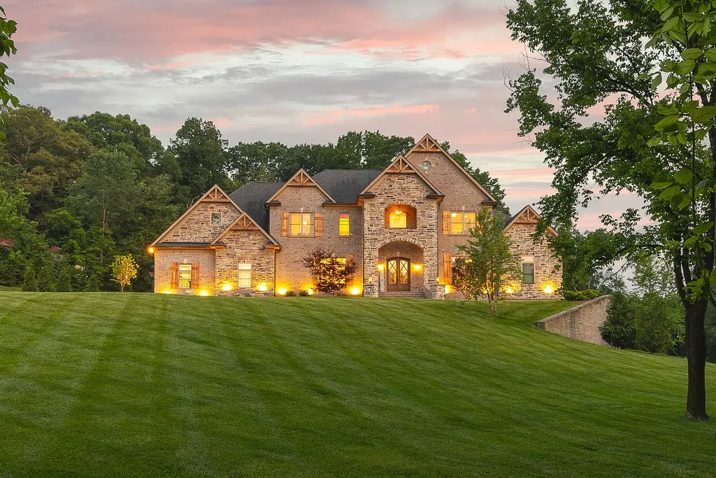 5078 Central Pike Home in Mount Juliet, Tennessee. Discover the epitome of luxury living in this stunning custom home situated on nearly 8 acres in Wilson County. Boasting a spacious floor plan, this residence features 5 bedroom suites, a workout room, a hobby room/office, and an outdoor entertaining area complete with a kitchen, custom pool, hot tub, and fire pit. Step into the indoor kitchen, which showcases leathered granite and quartz countertops, as well as a walk-in pantry. The main level and master bath offer the comfort of heated tile flooring.