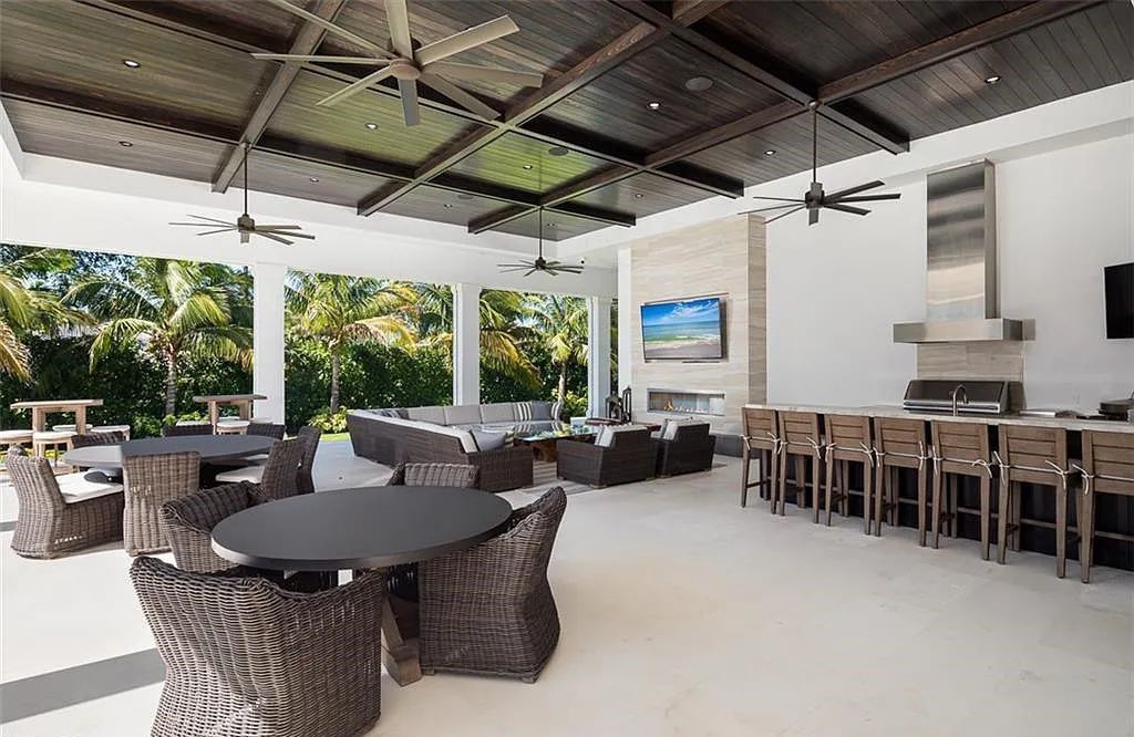 Welcome to 149 Cajeput Drive, Naples, Florida - a newly constructed masterpiece of timeless elegance. This exceptional estate boasts 5 bedrooms, 8 bathrooms, and spans 9,833 square feet.