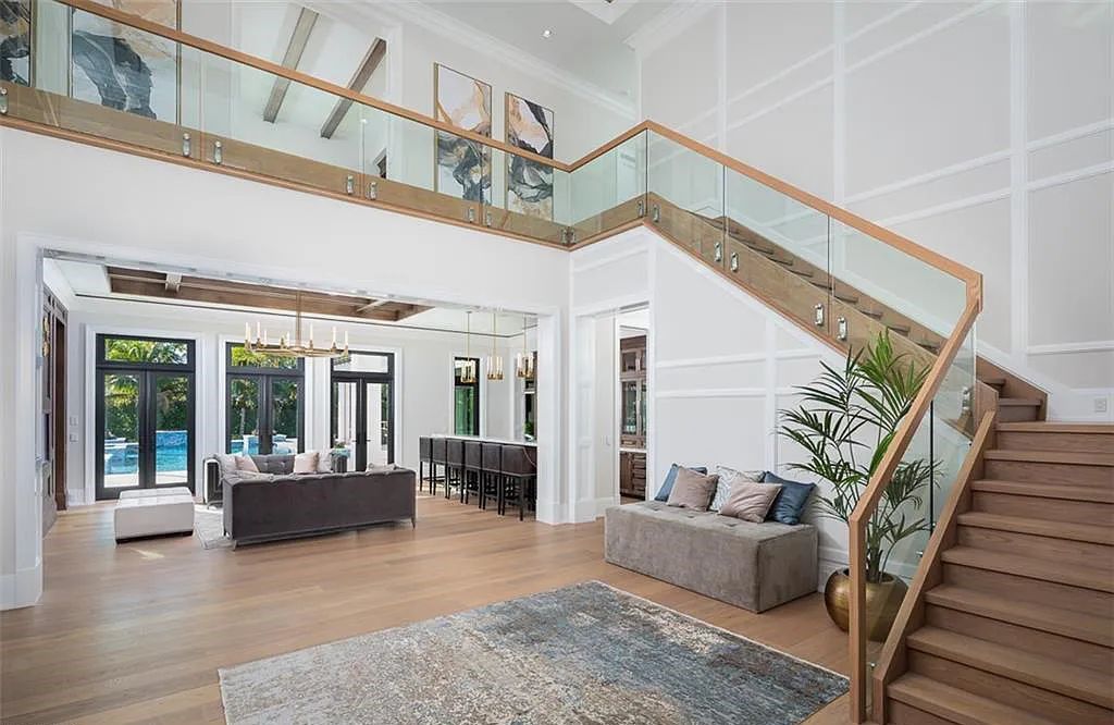 Welcome to 149 Cajeput Drive, Naples, Florida - a newly constructed masterpiece of timeless elegance. This exceptional estate boasts 5 bedrooms, 8 bathrooms, and spans 9,833 square feet.