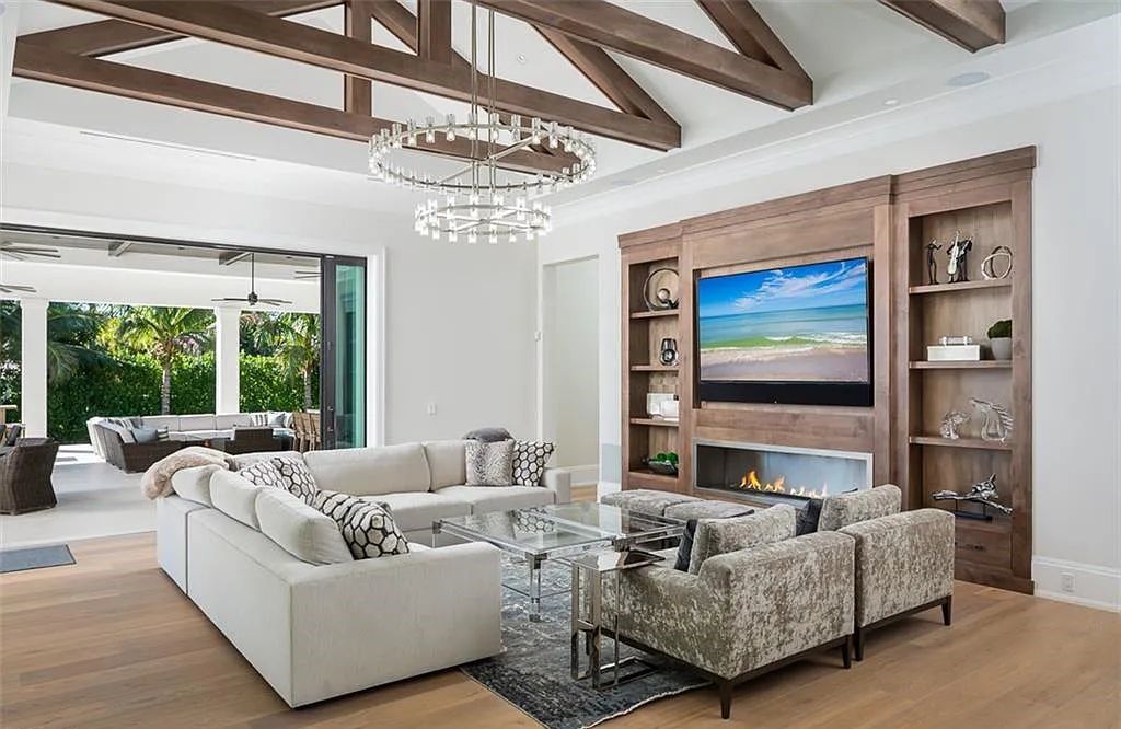 Welcome to 149 Cajeput Drive, Naples, Florida - a newly constructed masterpiece of timeless elegance. This exceptional estate boasts 5 bedrooms, 8 bathrooms, and spans 9,833 square feet.